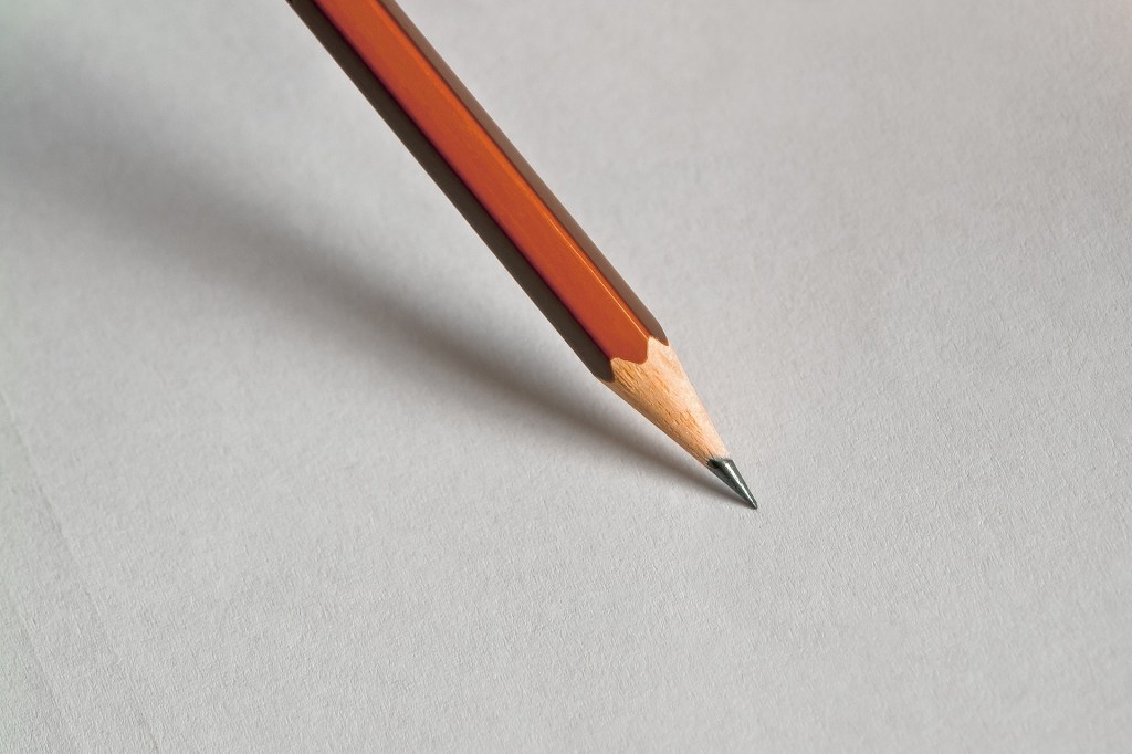 A pencil on a blank piece of paper.